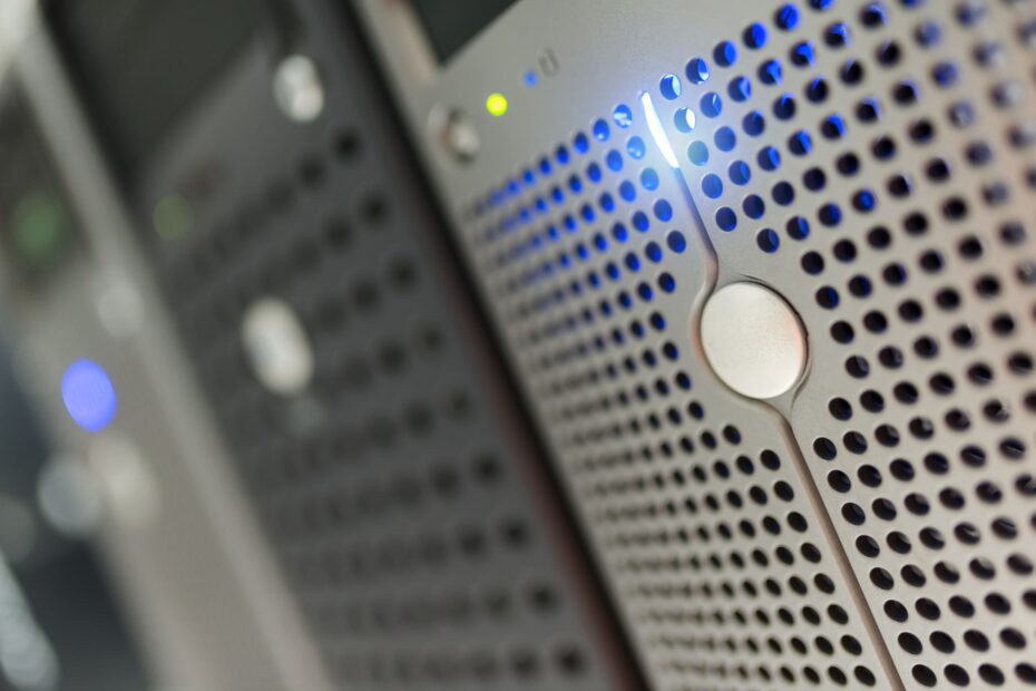 Focused detail of a modern server rack with blue LED indicators in a data center. (Photo by panumas nikhomkhai on Pexels)