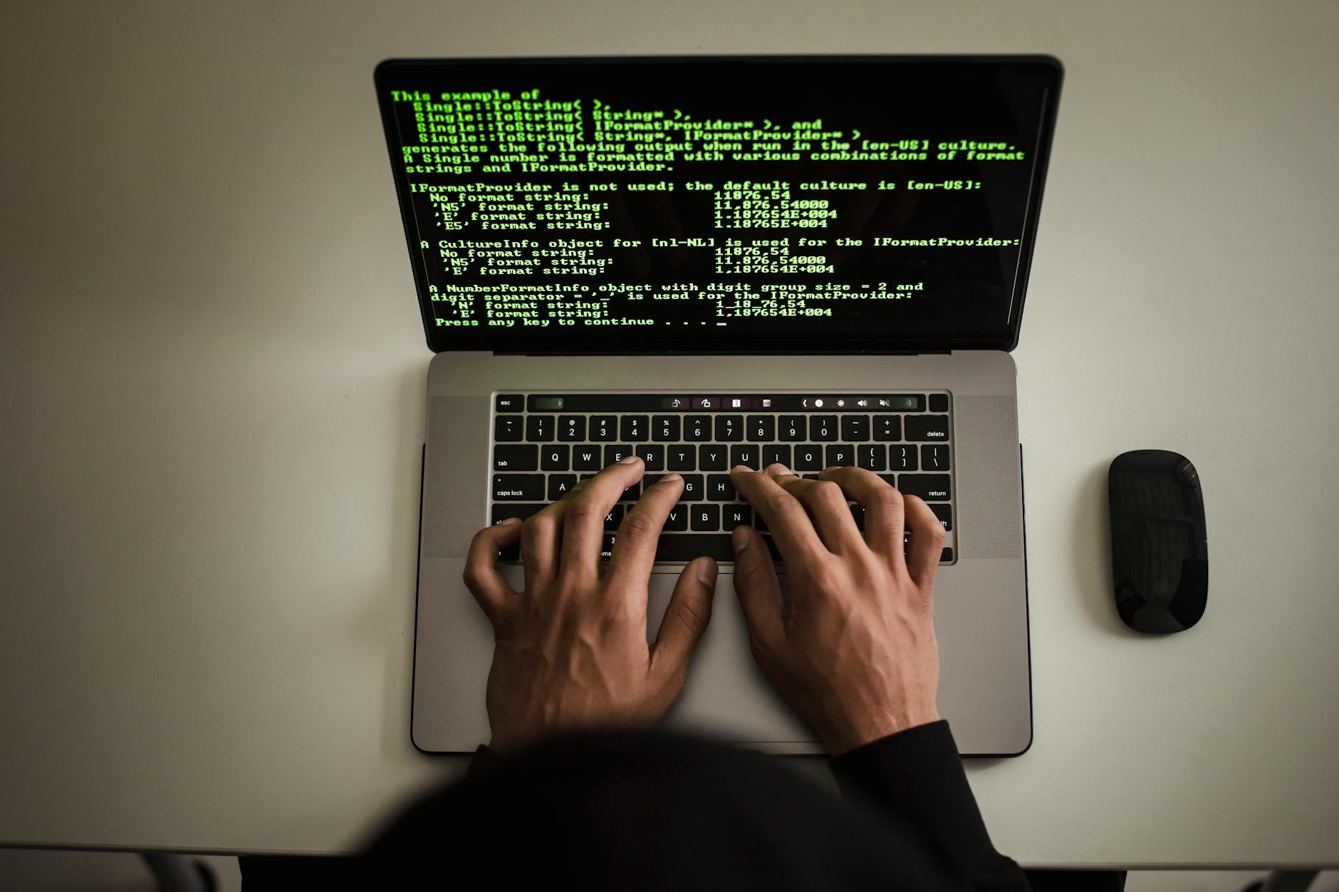 From above crop anonymous male programmer in black hoodie working on software code on contemporar... (Photo by Sora Shimazaki on Pexels)