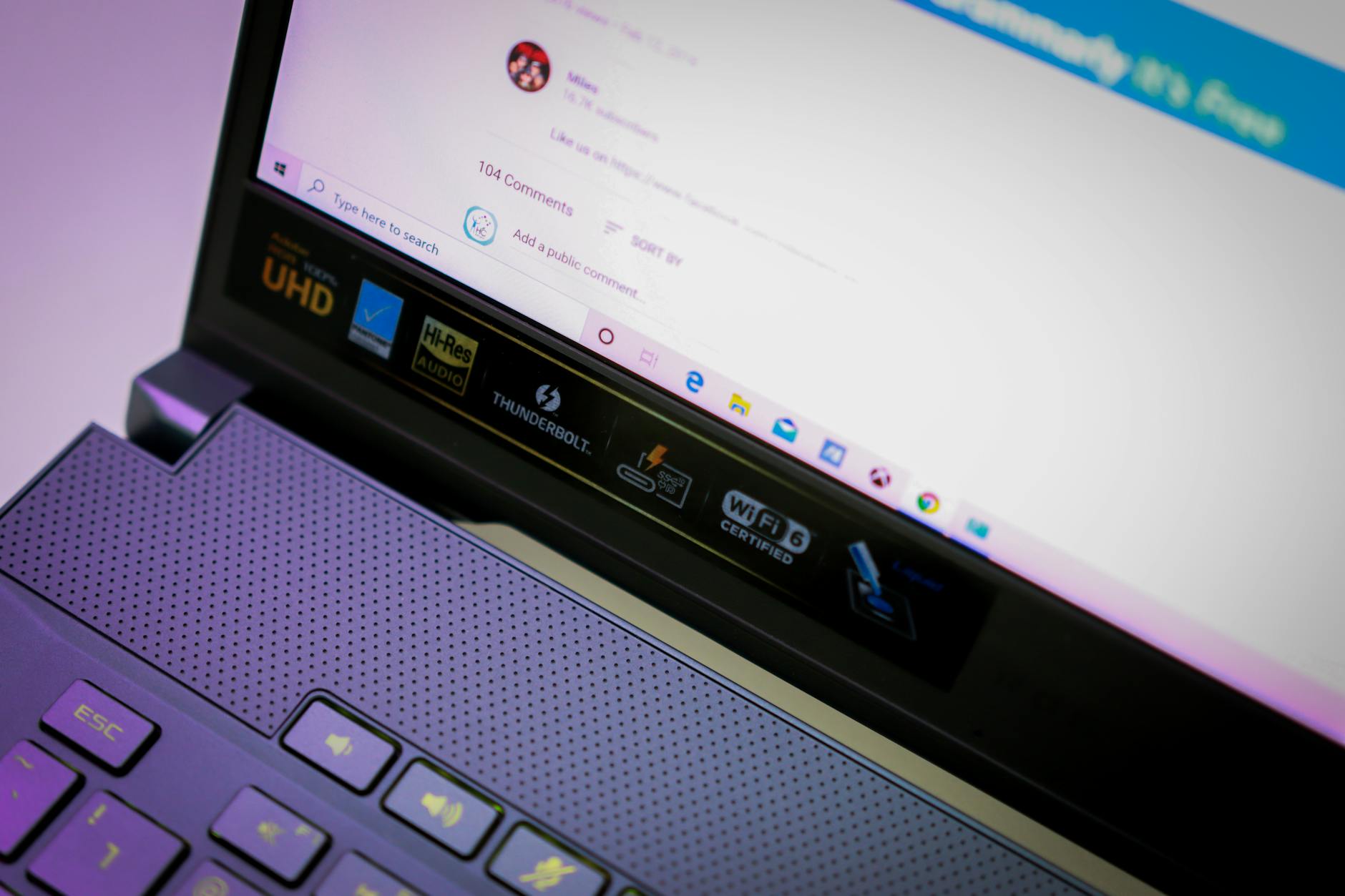 Close-up of an open laptop focusing on screen and keyboard with various icons and text. (Photo by Foysal Ahmed on Pexels)