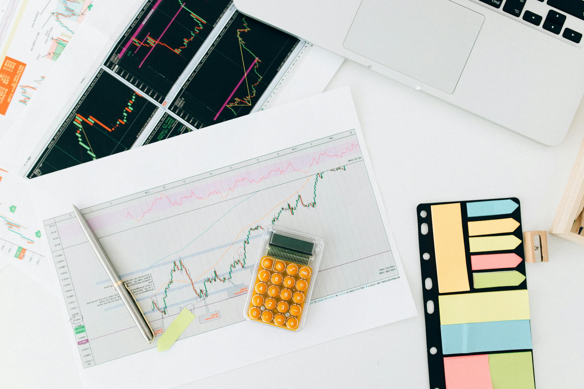 Flat lay of financial charts and tools on office desk, ideal for business and finance concepts. (Photo by Nataliya Vaitkevich on Pexels)