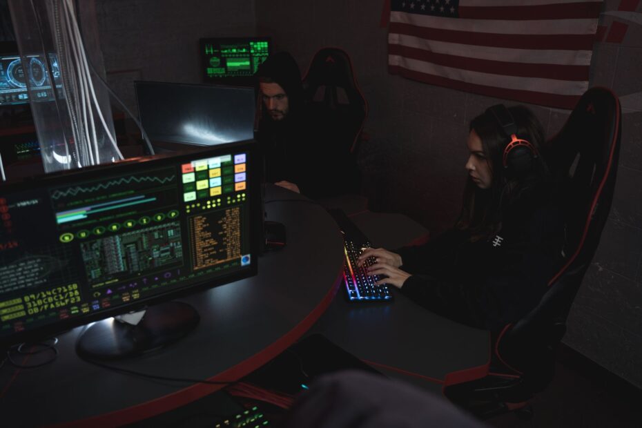 Cybersecurity professionals working on computer systems, focusing on data protection in a dimly l... (Photo by Tima Miroshnichenko on Pexels)